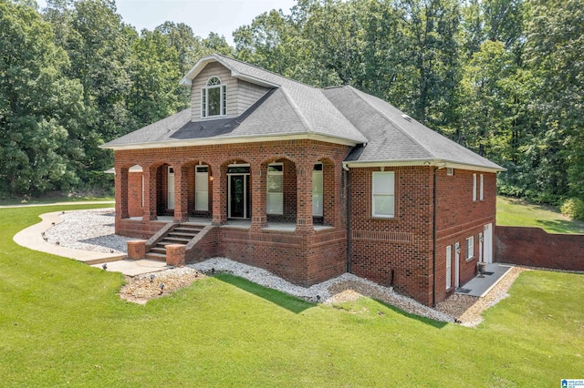 view of front of home featuring a shingled roof, brick siding, a porch, and a front lawn