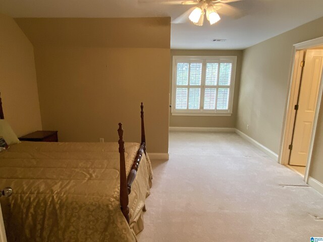 bedroom featuring baseboards, a ceiling fan, visible vents, and light colored carpet