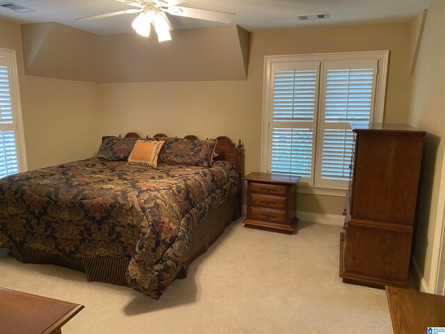 bedroom featuring light carpet, multiple windows, and visible vents