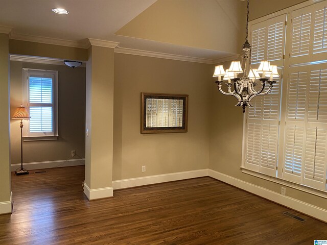 unfurnished dining area with ornamental molding, wood finished floors, visible vents, and baseboards