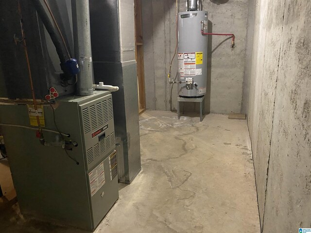 utility room featuring gas water heater and heating unit