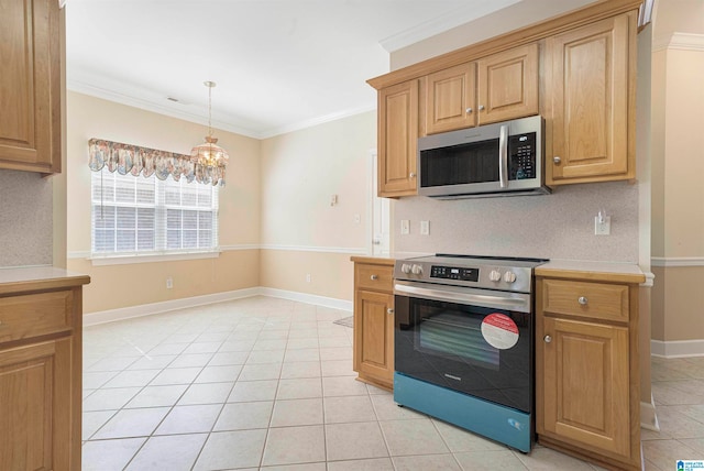 kitchen with appliances with stainless steel finishes, light tile patterned floors, a chandelier, and ornamental molding