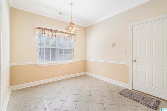 tiled spare room with ornamental molding and an inviting chandelier