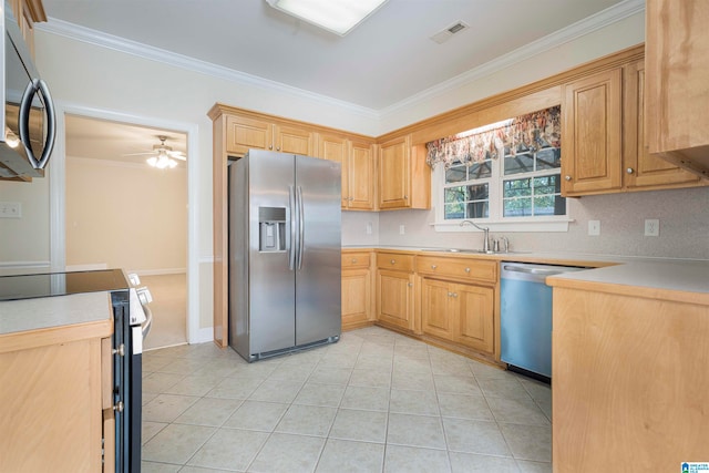 kitchen with appliances with stainless steel finishes, ornamental molding, sink, ceiling fan, and light tile patterned flooring