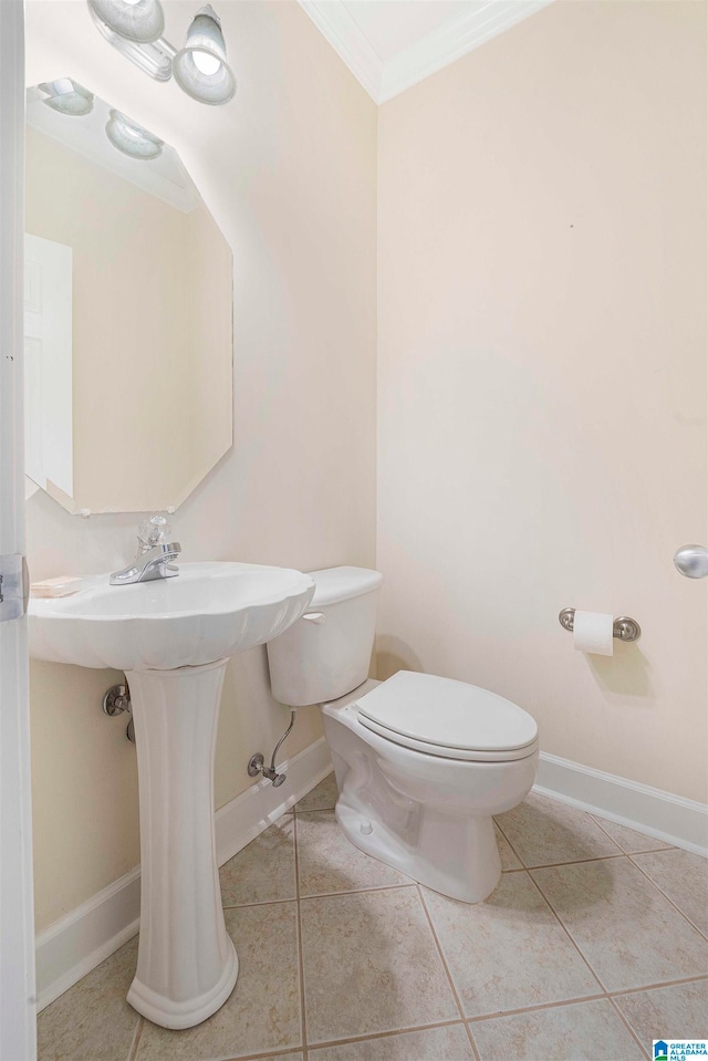 bathroom with toilet, ornamental molding, and tile patterned floors