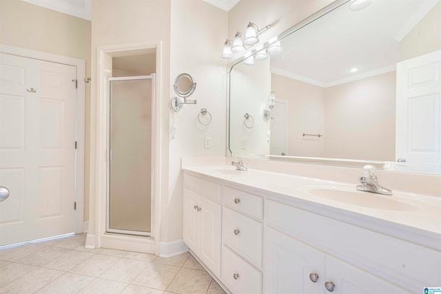 bathroom featuring tile patterned flooring, a shower with door, crown molding, and vanity