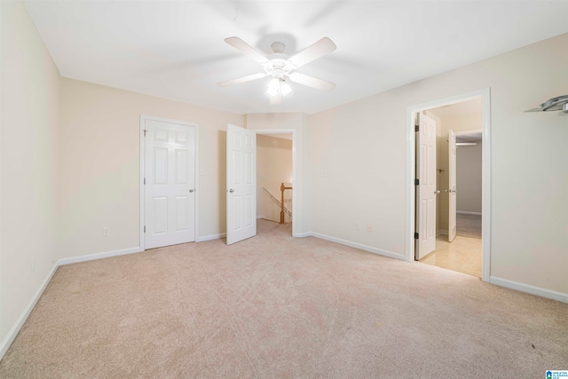 unfurnished bedroom with ceiling fan, connected bathroom, and light carpet