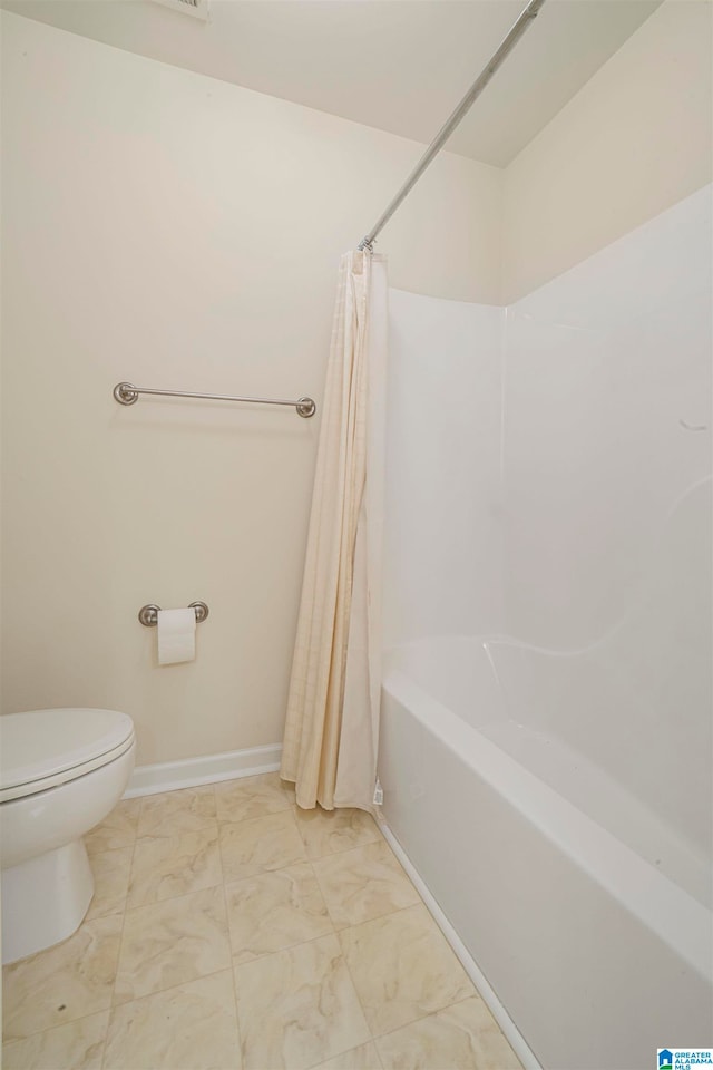 bathroom with toilet and shower / tub combo with curtain