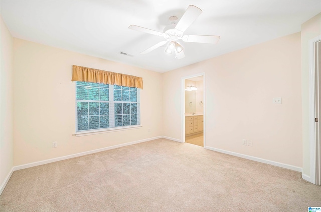 spare room featuring ceiling fan and light carpet