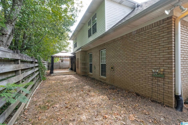 view of side of home featuring a gazebo