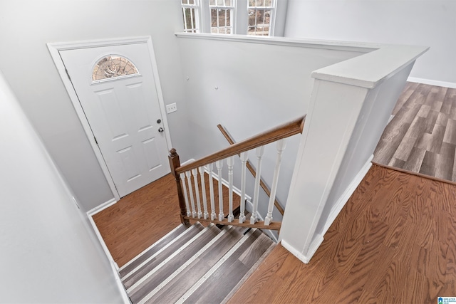 stairs featuring baseboards and wood finished floors