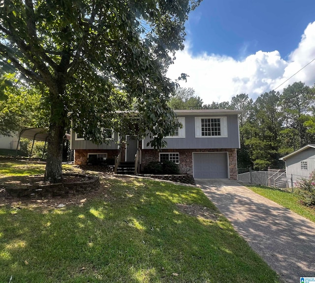 split foyer home featuring a carport, a garage, and a front lawn