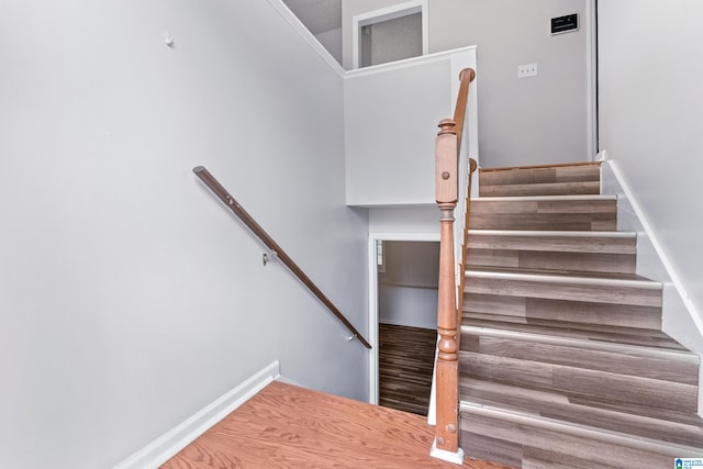 stairway featuring wood finished floors