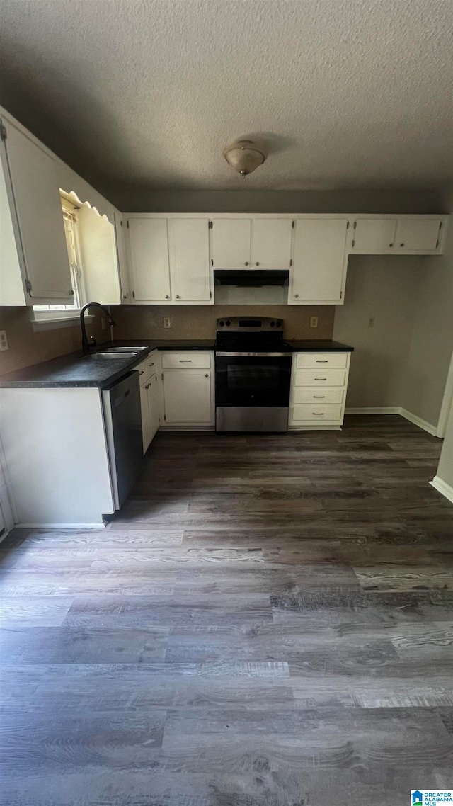 kitchen with appliances with stainless steel finishes, a textured ceiling, sink, white cabinets, and dark hardwood / wood-style floors