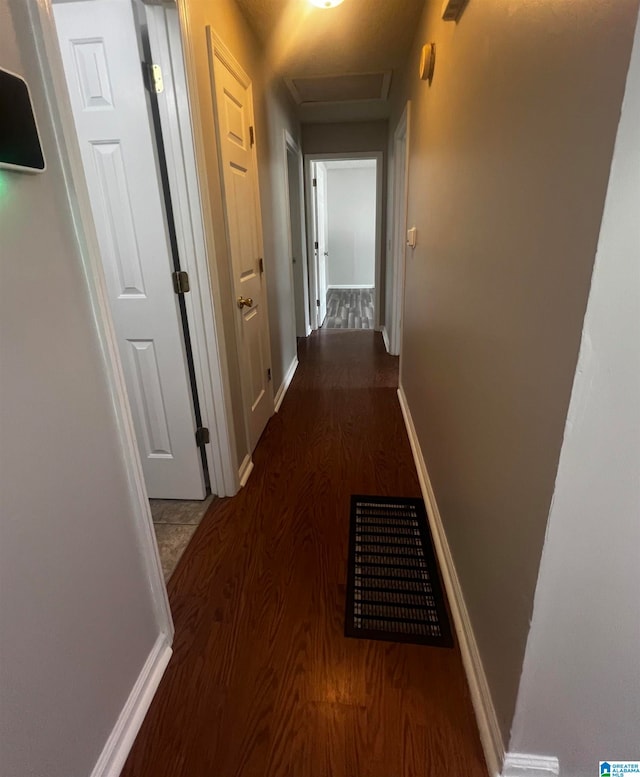 corridor featuring dark hardwood / wood-style flooring