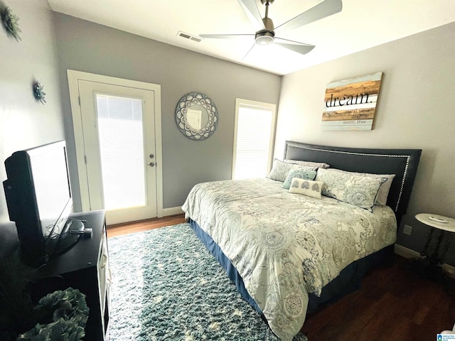 bedroom featuring a ceiling fan, baseboards, visible vents, and dark wood-style flooring