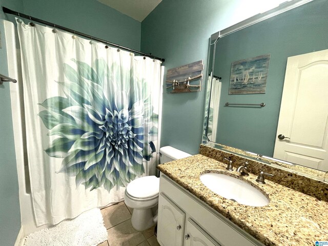 bathroom with tile patterned floors, toilet, walk in shower, and vanity