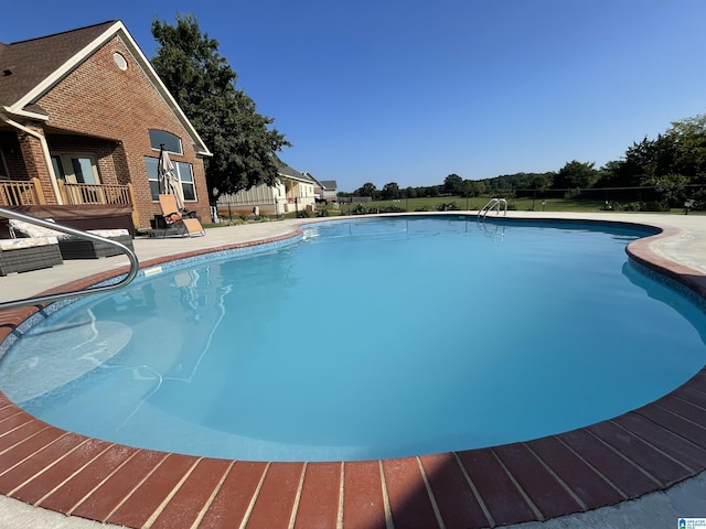 view of swimming pool with a patio area