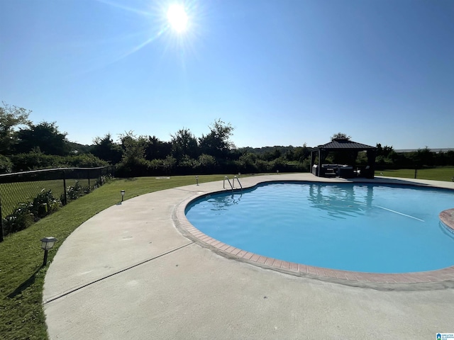 view of pool featuring a gazebo, a lawn, fence, and a fenced in pool