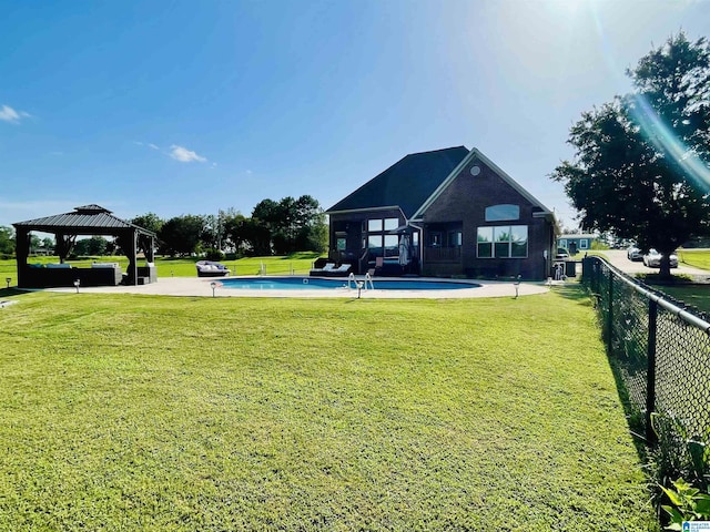 view of yard with fence, a fenced in pool, and a gazebo