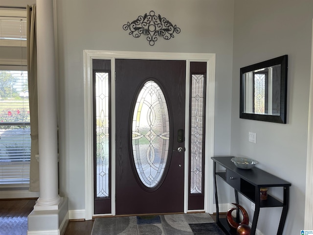 entrance foyer with plenty of natural light, decorative columns, and baseboards