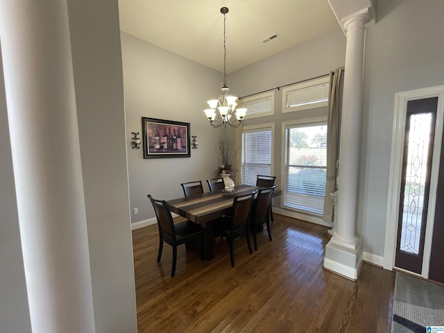 dining area with dark wood finished floors, ornate columns, visible vents, a chandelier, and baseboards