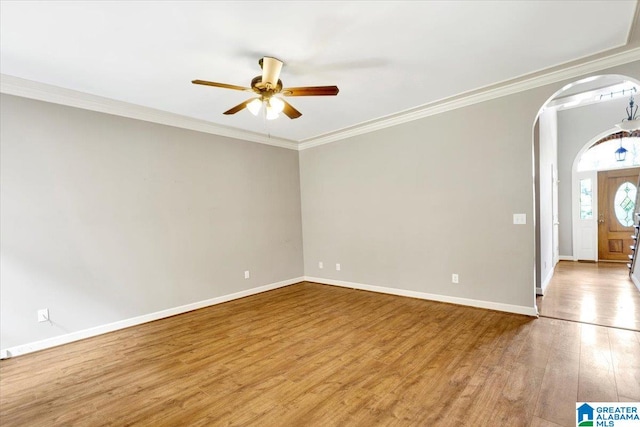 entryway featuring ceiling fan, light wood-type flooring, and ornamental molding