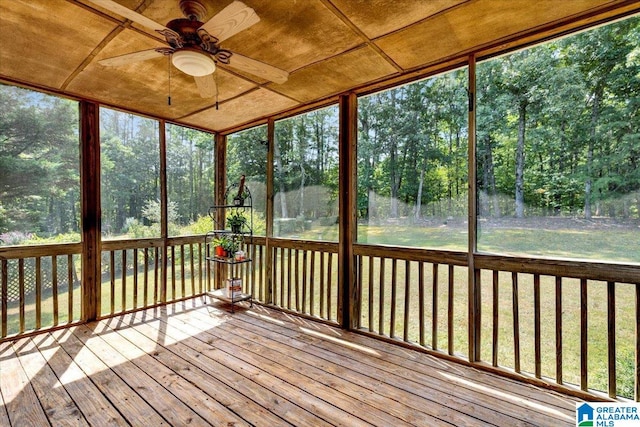 unfurnished sunroom featuring ceiling fan