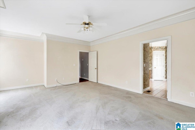 carpeted spare room with ceiling fan and ornamental molding