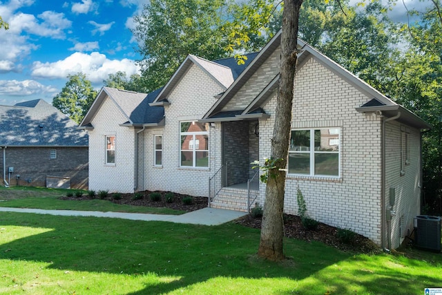 view of front of house featuring a front lawn and central AC unit