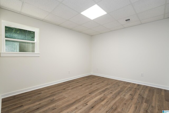 unfurnished room featuring a drop ceiling and hardwood / wood-style flooring