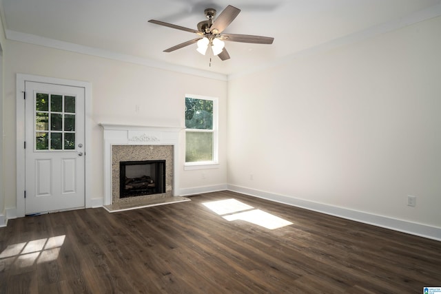 unfurnished living room featuring ceiling fan, dark hardwood / wood-style floors, and ornamental molding