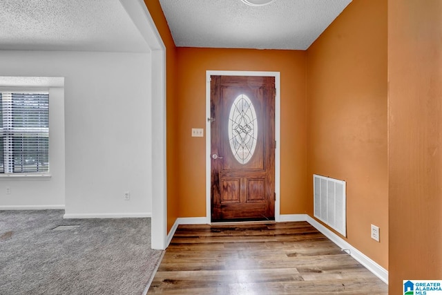 entrance foyer featuring hardwood / wood-style flooring and a textured ceiling