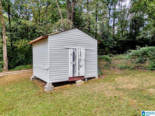 view of outbuilding with a lawn