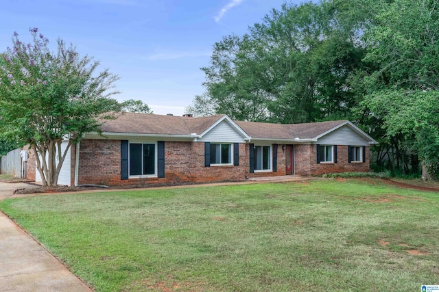 ranch-style home with a garage and a front lawn