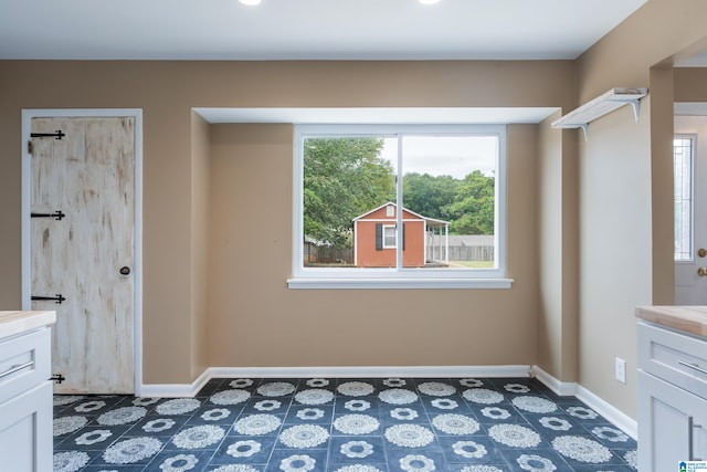 interior space featuring tile patterned flooring, plenty of natural light, and vanity