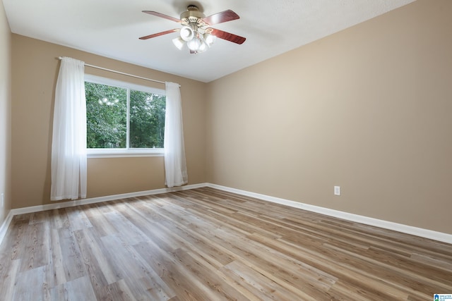 spare room featuring ceiling fan and light hardwood / wood-style flooring