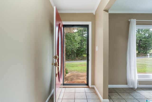 entryway with crown molding and light tile patterned flooring