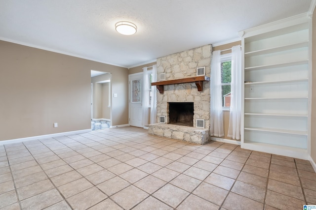 unfurnished living room featuring light tile patterned flooring, a stone fireplace, a textured ceiling, and built in features