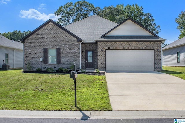 view of front of house with a garage, a front lawn, and central AC