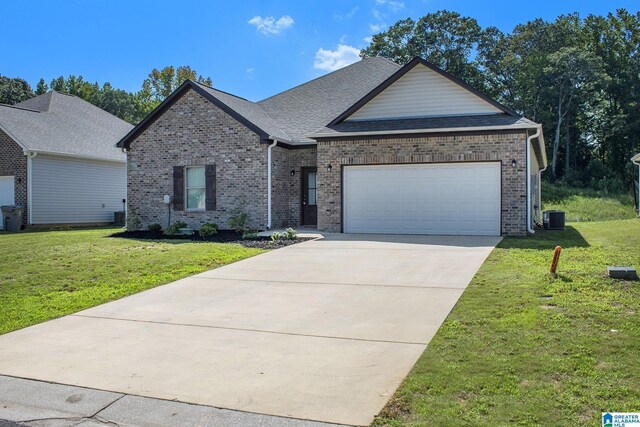 view of front of property with a garage, central air condition unit, and a front lawn