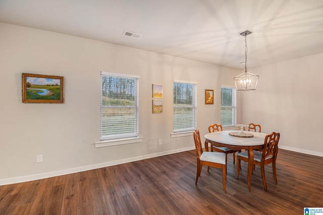 dining room featuring an inviting chandelier, baseboards, visible vents, and dark wood-type flooring