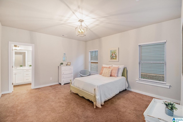 bedroom with light carpet, ensuite bath, baseboards, and an inviting chandelier