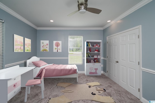 bedroom with a closet, ceiling fan, crown molding, and light carpet