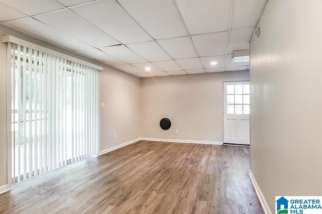 unfurnished room featuring a paneled ceiling and wood-type flooring