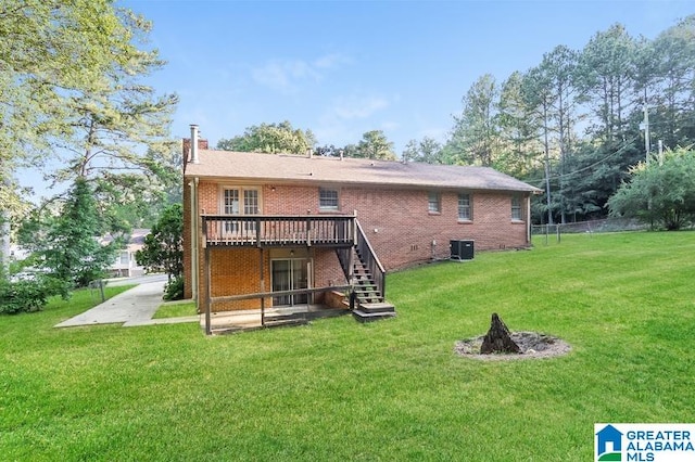 back of property featuring a wooden deck, cooling unit, and a yard