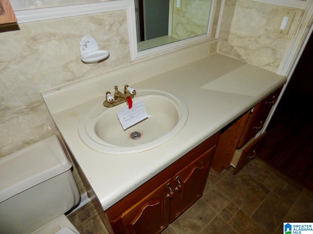 bathroom featuring toilet and vanity