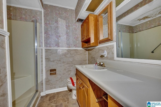 bathroom featuring a shower with shower door, toilet, vanity, and crown molding