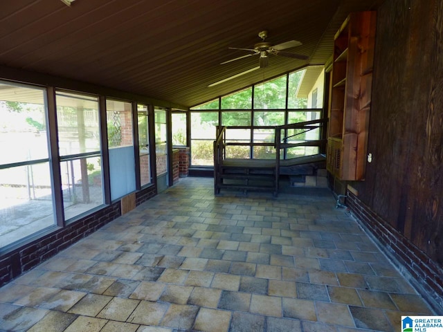 unfurnished sunroom with wooden ceiling, lofted ceiling, and ceiling fan