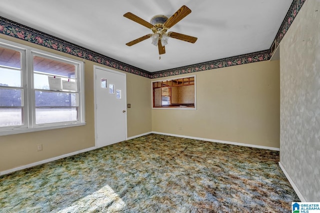 unfurnished room featuring ceiling fan, baseboards, and carpet flooring